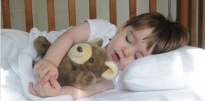 Little boy sleeping with teddy bear